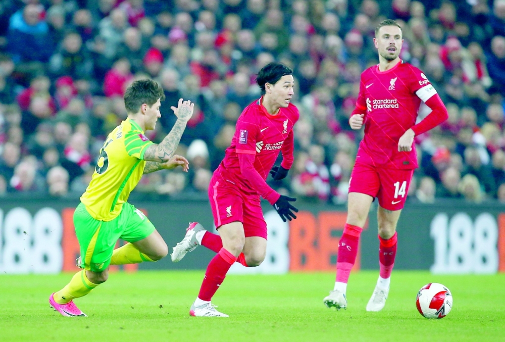 Minamino double sends Liverpool into last eight